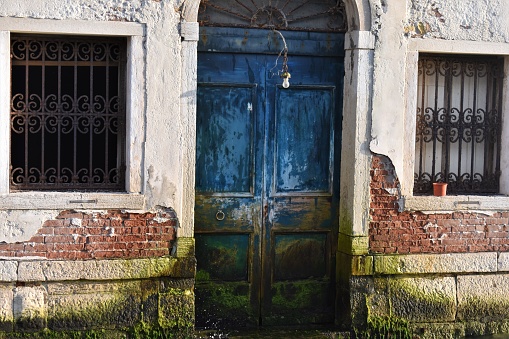 A bold blue door facing the Grand Canal in Venice Italy