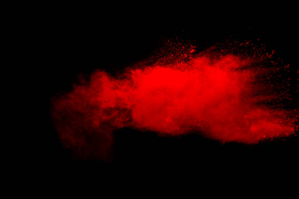 istock Abstract red dust explosion on black background. Freeze motion of red powder splash. 1258358066