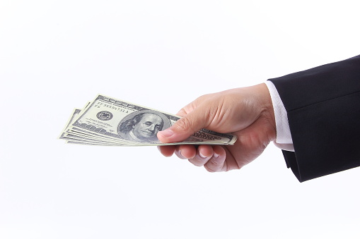 Business man hand holding money, isolated on white background