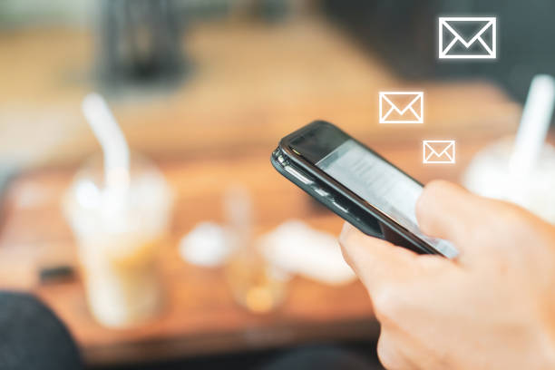 istock Woman hand using smartphone and it's show email recieve notification icon pop up on screen of mobile phone. Business communication  technology concept. 1258405136