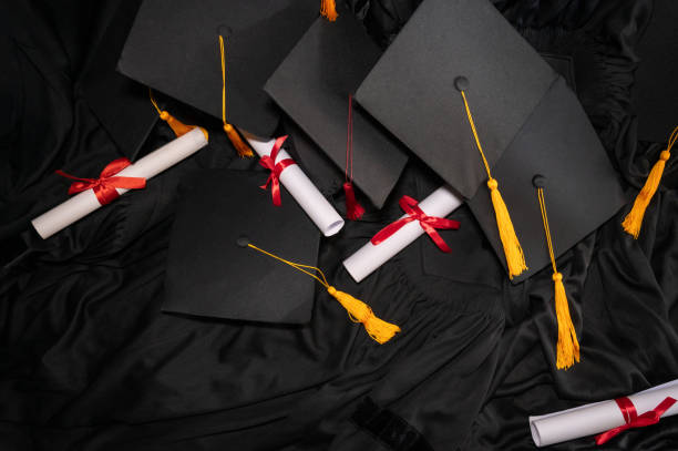 istock graduation cap placed on a black academic gown,Education concept 1258446852