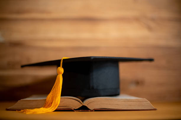 istock graduation cap over open Books on wood background,Education concept 1258446876