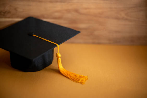 istock graduation cap placed Brown paper,Education concept 1258446882