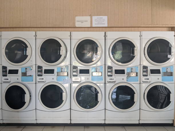 Coin laundromat in Tangerang Tangerang, Indonesia - June 4, 2020: Rows of laundry washing machines and drying machines at Whiz Coin Laundry. tangerang photos stock pictures, royalty-free photos & images