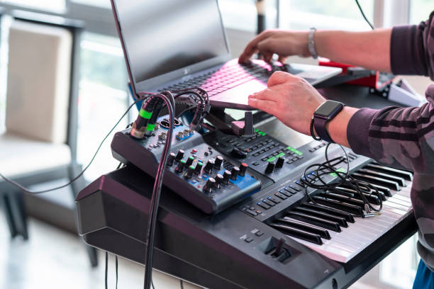 istock Man conducting a conference call on his laptop playing music on his console 1258525475