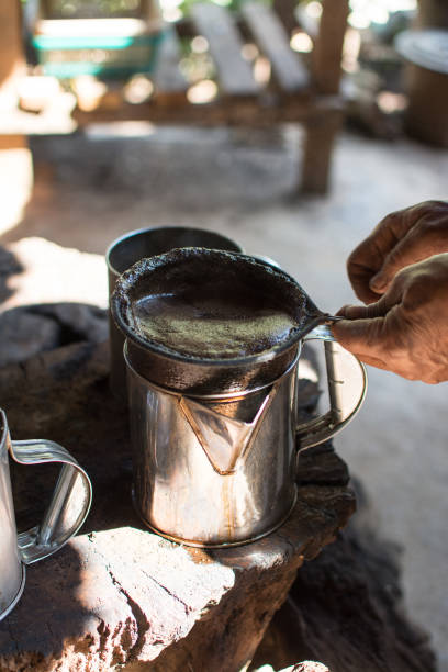istock hand holding coffee  bag filter while filtering traditional Thai coffee. 1258525991