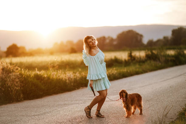istock Woman walking with her dog 1258531718