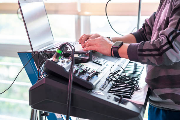 istock Man conducting a conference call on his laptop playing music on his console 1258532770