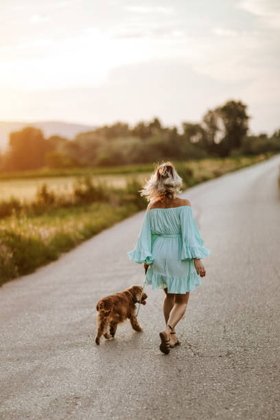 istock Woman walking with her dog 1258533294