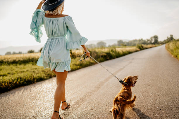 istock Woman walking with her dog 1258535948
