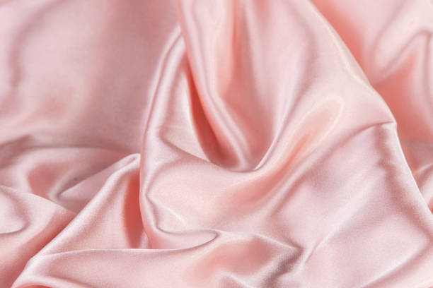istock Close up. Pink silk wrinkle fabric texture. 1258541152