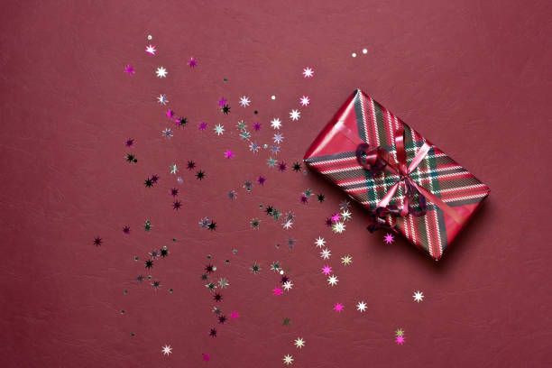 istock Christmas still life with gift box and   confetti, top view 1258554355