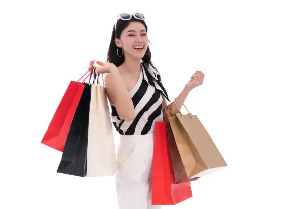 cheerful young woman holding shopping bag isolated on a white background