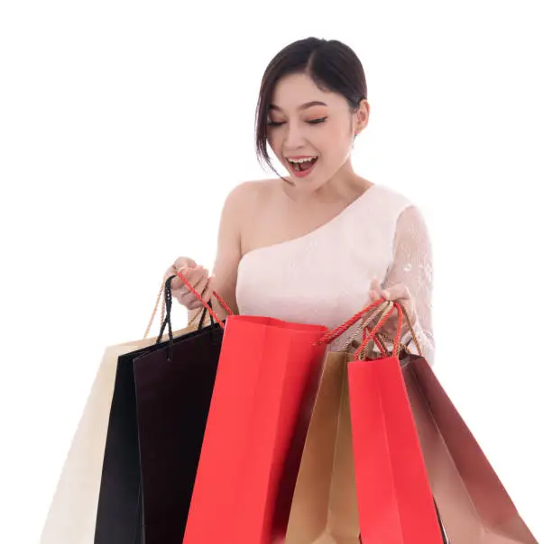 surprised woman holding opened shopping bag isolated on a white background