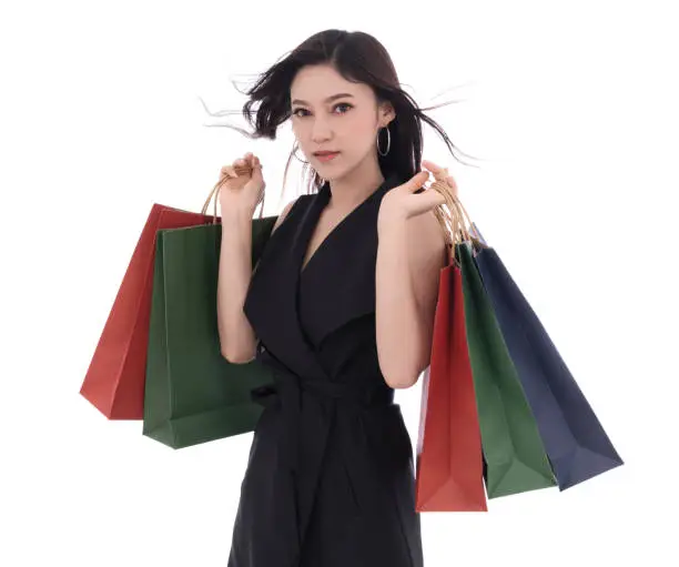 beautiful woman holding shopping bag isolated on a white background