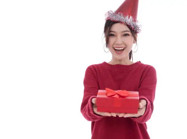 happy young woman with hat and holding a christmas gift box isolated on a white background