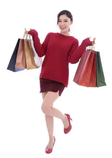 happy young woman holding shopping bag isolated on a white background
