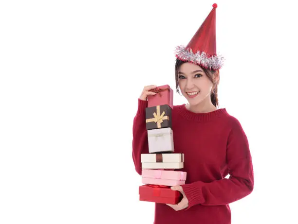 happy young woman with hat and holding a christmas gift box isolated on a white background