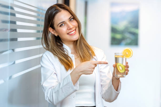 istock Dietitian doctor showing lemon juice with forefinger 1258592432