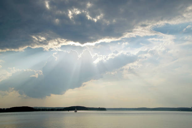 istock Quiet summer warm evening over the lake. Sun and clouds. Sunset. Horizontal landscape 1258601300
