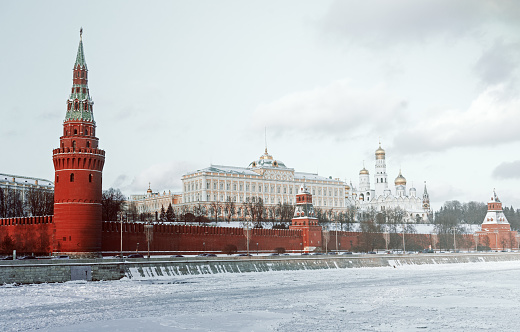 Moscow Kremlin and frozen river on a clear winter day.