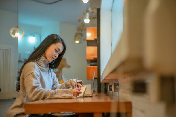 istock Asian woman writing. 1258622022