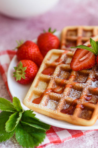istock Delicious fresh baked belgian waffles with berries and fruit 1258647593
