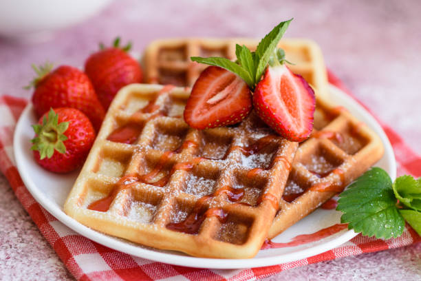 istock Delicious fresh baked belgian waffles with berries and fruit 1258647617