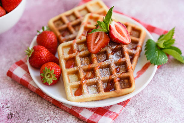 istock Delicious fresh baked belgian waffles with berries and fruit 1258647647