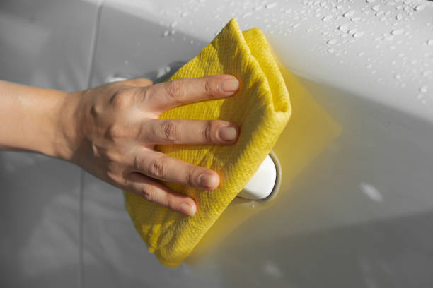 istock hand with microfiber cloth cleaning car roof 1258654191