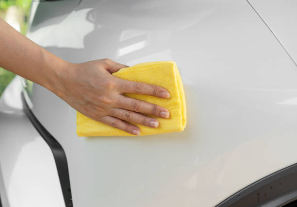istock hand with microfiber cloth cleaning car roof 1258654386