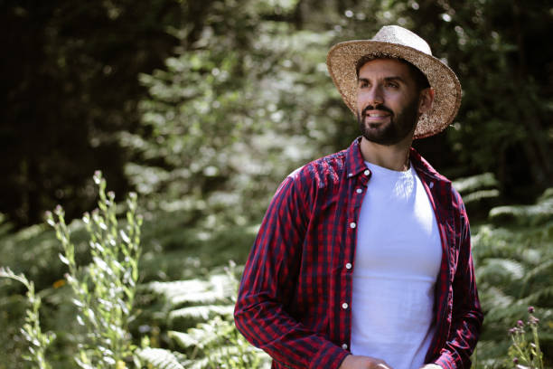 istock Handsome man with a hat explores the forest on a sunny day 1258681386