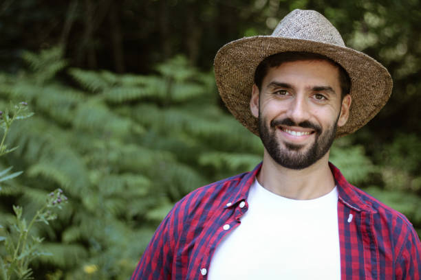 istock Handsome man with a hat explores the forest on a sunny day 1258681958