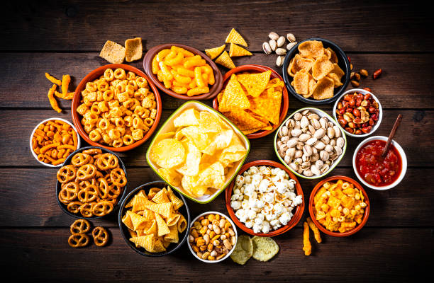 istock Salty snacks assortment shot from above on rustic wooden table 1258687192