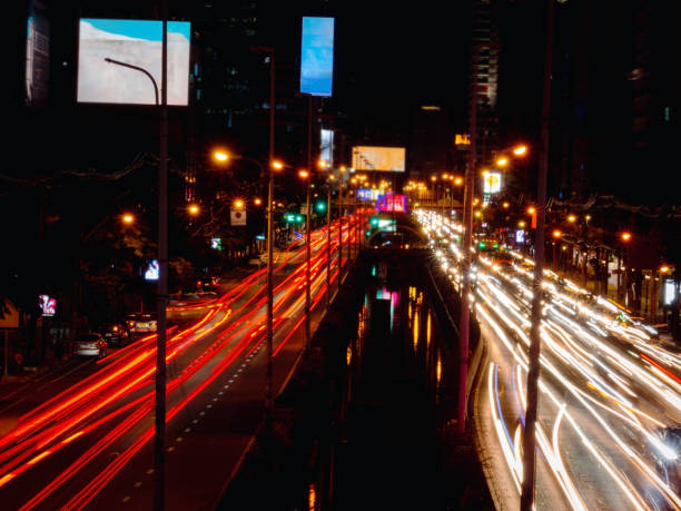 istock Long exposure light trails on the street at night, motion speed traffic light with blurred traces from cars on road 1258690326