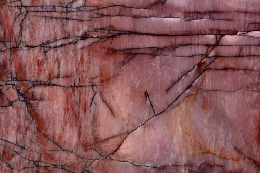 Quartzite background in elegant violet tone as part of your design, natural stone texture.