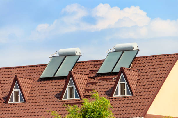 Solar water heaters on a residential house rooftop. Renewable energy for house Solar water heaters on a residential house rooftop. Renewable energy for house solar heater stock pictures, royalty-free photos & images