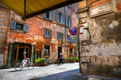 Rome, Italy, July 24 -- A cyclist runs a typical alley in the historic center of Rome between Via del Governo Vecchio and Via Sora, near Piazza Navona. Image in Hugh Definition format.