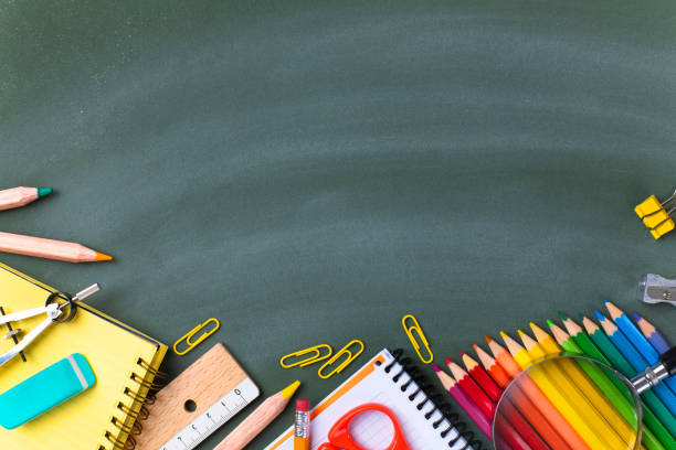 istock School supplies on blackboard. Back to school concept. 1258741022