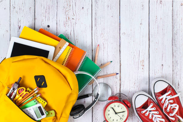 istock School backpack and school supplies on wooden background 1258748885