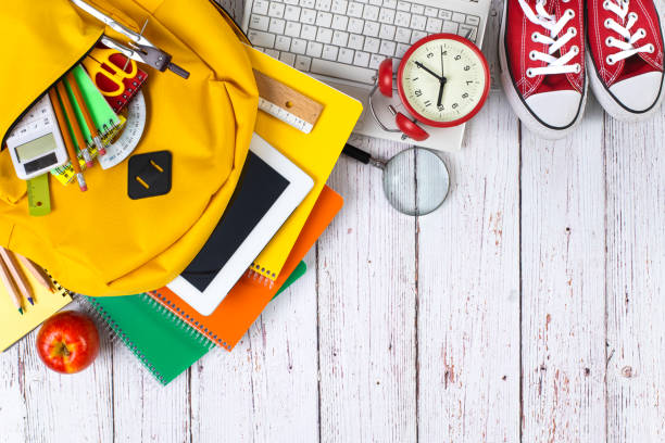 istock School backpack and school supplies on wooden background 1258751115