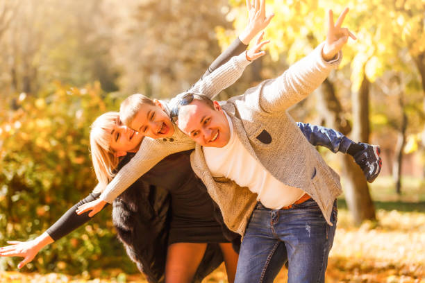 istock Family playing in autumn park having fun 1258789395