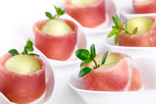 Prosciutto fingerfood in small white spoon\n\n[url=http://www.istockphoto.com/search/lightbox/6917851/][img]http://img535.imageshack.us/img535/1977/finetitle.jpg[/img][/url]