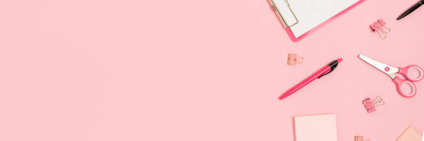 istock Banner with scattered office supplies on a pink background. 1258830014