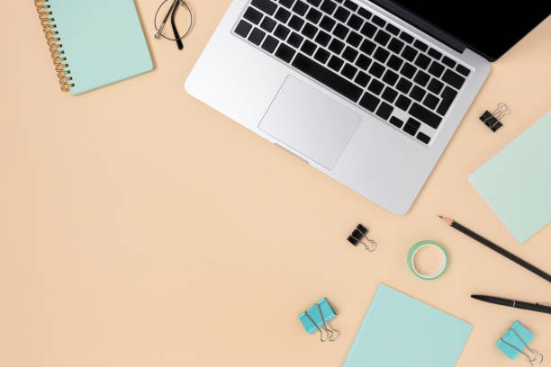 istock Workspace with laptop and stationery on a beige background. 1258833196