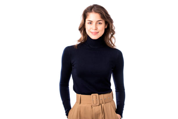 istock Beautiful young woman standing at isolated white background while looking at camera and smiling 1258842103