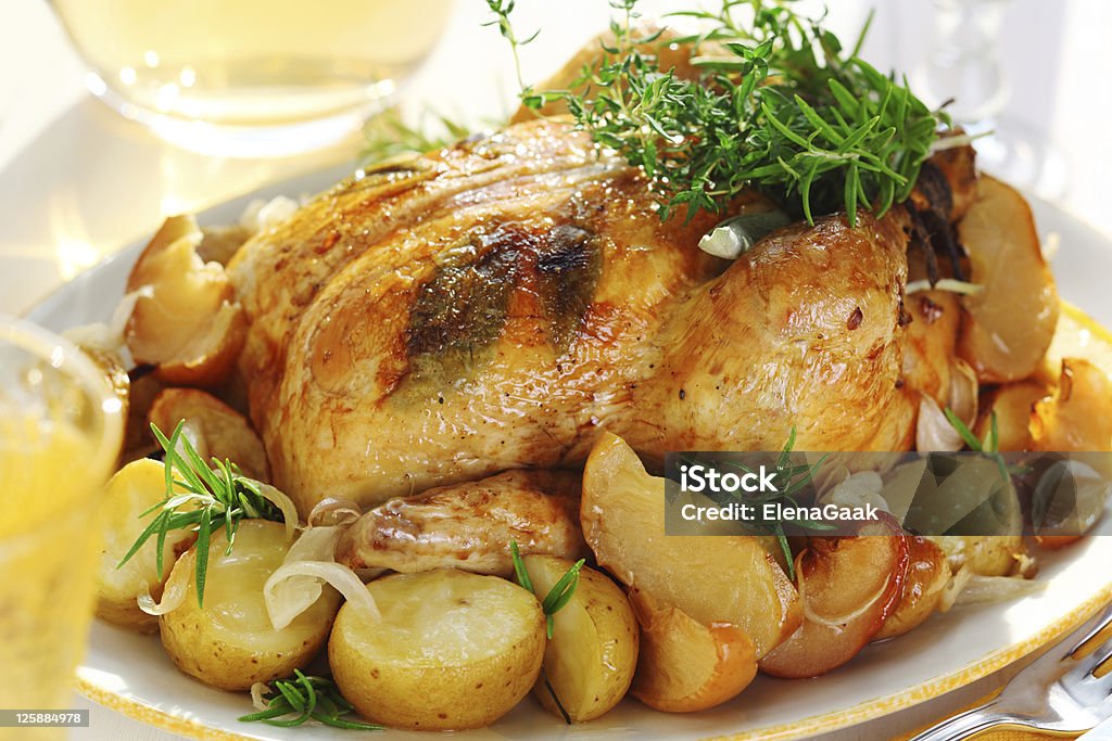 Whole roasted chicken with potatoes and provencal herbs Apple - Fruit Stock Photo