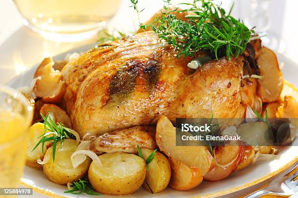 Whole Roasted Chicken With Potatoes And Provencal Herbs Stock Photo - Download Image Now