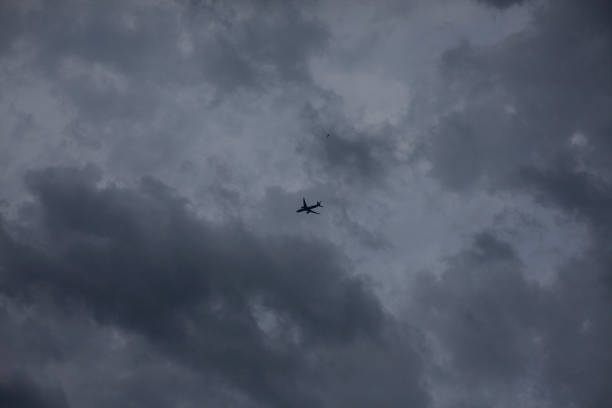 istock Airplane in the cloudy sky. 1258852517