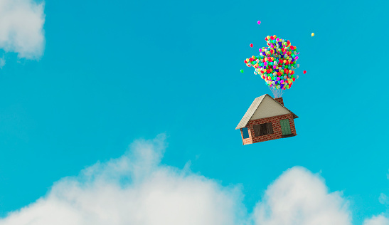 Small house flys up in the air after balloons with helium has been attaches to the chimney.